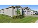 Exterior elevation of a single-story home with a gray facade, white trim, and a two-car garage at 6535 Shimmering Shores Ln, St Cloud, FL 34771