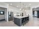 Stylish kitchen with large island, pendant lighting, and stainless steel appliances at 6535 Shimmering Shores Ln, St Cloud, FL 34771