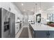 Modern kitchen featuring white cabinets, stainless steel appliances, and a large center island at 6535 Shimmering Shores Ln, St Cloud, FL 34771