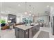 Spacious kitchen with a large island and open sightlines to the dining area and living room at 6535 Shimmering Shores Ln, St Cloud, FL 34771