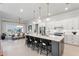 Modern kitchen with a large island, stainless steel appliances, and white cabinetry at 6535 Shimmering Shores Ln, St Cloud, FL 34771