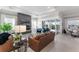Contemporary living room with fireplace, large windows, and sliding glass doors to a patio at 6535 Shimmering Shores Ln, St Cloud, FL 34771