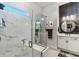 Luxurious main bathroom with marble tile, glass shower, and modern fixtures at 6535 Shimmering Shores Ln, St Cloud, FL 34771