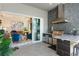 Outdoor kitchen with stainless steel appliances, stone countertops, and sliding doors leading indoors at 6535 Shimmering Shores Ln, St Cloud, FL 34771