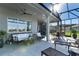 Covered patio with outdoor kitchen, seating area, and ample natural light at 6535 Shimmering Shores Ln, St Cloud, FL 34771