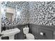 Powder room featuring stylish wallpaper, wainscoting, and pedestal sink at 6535 Shimmering Shores Ln, St Cloud, FL 34771