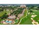 An aerial view of a golf course community with homes and amenities at 7632 Excitement Dr, Reunion, FL 34747