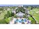 Community aerial view showcasing the clubhouse, pool, golf course, and surrounding homes at 7632 Excitement Dr, Reunion, FL 34747