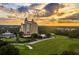 Sunset aerial view of a resort building and a golf course at 7632 Excitement Dr, Reunion, FL 34747