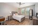 A comfortable bedroom featuring a bed, desk, and ample natural light at 7999 Chilton Dr, Orlando, FL 32836