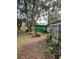 Backyard with trees, plants, and a shed-like structure at 826 Rosalia Dr, Sanford, FL 32771