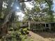 Exterior view of the house with screened porch and landscaping at 826 Rosalia Dr, Sanford, FL 32771