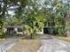 Front exterior view of a home with palm trees, a driveway, and landscaping at 826 Rosalia Dr, Sanford, FL 32771