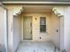 The townhouse entrance includes a covered porch, front door, and address numbers at 12240 Triton Ln # 7, Orlando, FL 32837