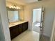 View of the double vanity and doorway leading to the bedroom at 14563 Crestavista Ave, Clermont, FL 34714