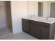 Modern bathroom with double vanity, dark wood cabinets, and tiled floors at 14568 Crestavista Ave, Clermont, FL 34714