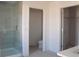 Bathroom with a glass shower, toilet, and a walk-in closet at 14568 Crestavista Ave, Clermont, FL 34714