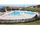 Community pool with splash pad and lounge chairs at 14568 Crestavista Ave, Clermont, FL 34714