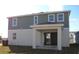 Two-story home with gray siding, white trim, and a covered patio at 14568 Crestavista Ave, Clermont, FL 34714