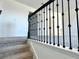 Carpeted staircase with black wrought iron railing leading to the second floor at 14568 Crestavista Ave, Clermont, FL 34714