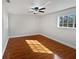 Bedroom featuring wood-look flooring, white walls, ceiling fan, and ample natural light at 148 Harwood Cir, Kissimmee, FL 34744