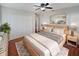 Inviting bedroom with wooden platform bed, white closet, nightstands, and patterned rug at 148 Harwood Cir, Kissimmee, FL 34744