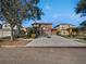 Two-story home with a driveway, landscaped yard, and attached garage at 148 Harwood Cir, Kissimmee, FL 34744