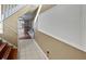 Hallway with a staircase and white trim accents, leading to an open living area at 148 Harwood Cir, Kissimmee, FL 34744