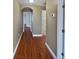 Hallway with wood-look flooring, neutral walls, and white trim at 148 Harwood Cir, Kissimmee, FL 34744