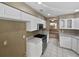 Kitchen with stainless steel appliances, white cabinets, and speckled granite counters at 148 Harwood Cir, Kissimmee, FL 34744