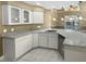 Modern kitchen with granite countertops, white cabinets, and stainless steel appliances at 148 Harwood Cir, Kissimmee, FL 34744