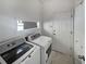 Laundry room with washer, dryer, and ample storage space at 148 Harwood Cir, Kissimmee, FL 34744