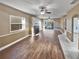 Living area with wood floors, fireplace, and access to the screened-in patio at 148 Harwood Cir, Kissimmee, FL 34744