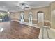 Spacious living room with wood floors, fireplace, and view of the pool at 148 Harwood Cir, Kissimmee, FL 34744