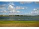 Scenic lake view with houses in the background under a cloudy sky at 1727 Wood Path, Auburndale, FL 33823