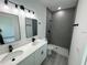 Modern bathroom with dual vanities, a walk-in shower, and contemporary fixtures at 17490 Sw 27Th Cir, Ocala, FL 34473