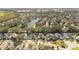 Residential area seen from an aerial perspective, showing houses, streets, trees, and a nearby lake at 1942 Willow Wood Dr, Kissimmee, FL 34746