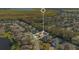 A home with a pool highlighted in an aerial view of a neighborhood with a lake in the background at 1942 Willow Wood Dr, Kissimmee, FL 34746