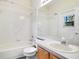 Clean bathroom with a tub, toilet, and vanity with a mirror at 1942 Willow Wood Dr, Kissimmee, FL 34746