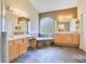 Large bathroom with dual vanities, a soaking tub, and tile flooring at 1942 Willow Wood Dr, Kissimmee, FL 34746