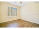 Empty bedroom with wood-look flooring and plantation shutters at 1942 Willow Wood Dr, Kissimmee, FL 34746