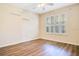 Bedroom with wood-look floors, plantation shutters, and built-in shelving at 1942 Willow Wood Dr, Kissimmee, FL 34746