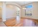 Spacious dining room with wood floors, large window, and archway at 1942 Willow Wood Dr, Kissimmee, FL 34746