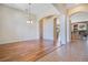 Open dining area with hardwood floors and archway leading to another room at 1942 Willow Wood Dr, Kissimmee, FL 34746