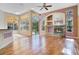 Living room with fireplace, wood floors, and large windows offering lots of natural light at 1942 Willow Wood Dr, Kissimmee, FL 34746