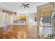 Open concept living space with wood floors, kitchen, fireplace, and access to the outdoors at 1942 Willow Wood Dr, Kissimmee, FL 34746
