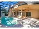 Inviting pool area enclosed by a screen cage at 1942 Willow Wood Dr, Kissimmee, FL 34746