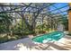 Screened-in pool surrounded by lush landscaping and trees at 1942 Willow Wood Dr, Kissimmee, FL 34746