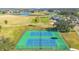 Two tennis courts in a community with a golf course and lake view in the distance at 1942 Willow Wood Dr, Kissimmee, FL 34746