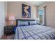 Inviting bedroom with blue and white plaid bedding and modern decor at 244 Villa Domani Cir, Davenport, FL 33896